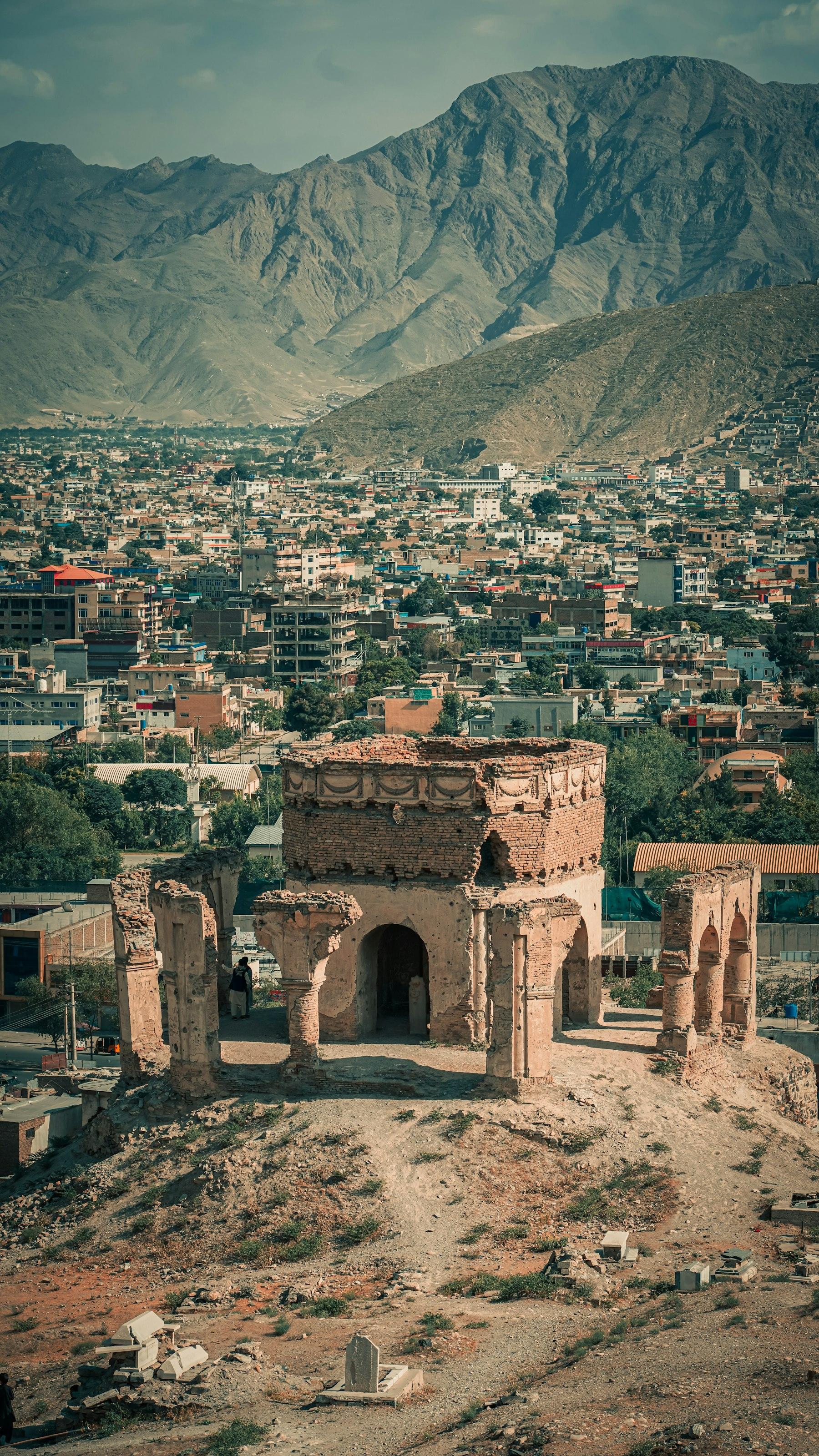 Historic hilltop structures overlooking a mountain city in Afghanistan